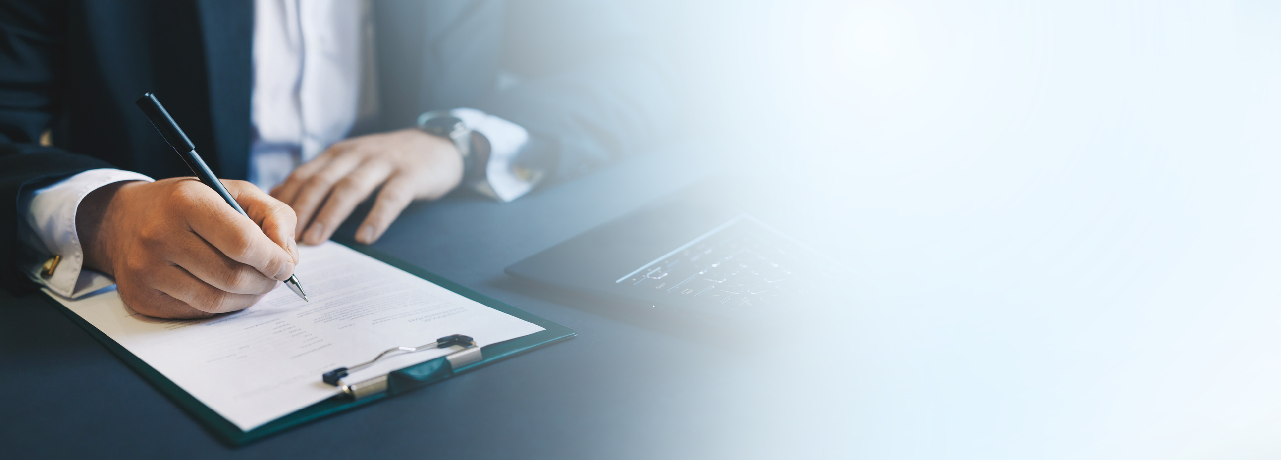 Businessman signing a document. Panoramic business banner with  copy space.